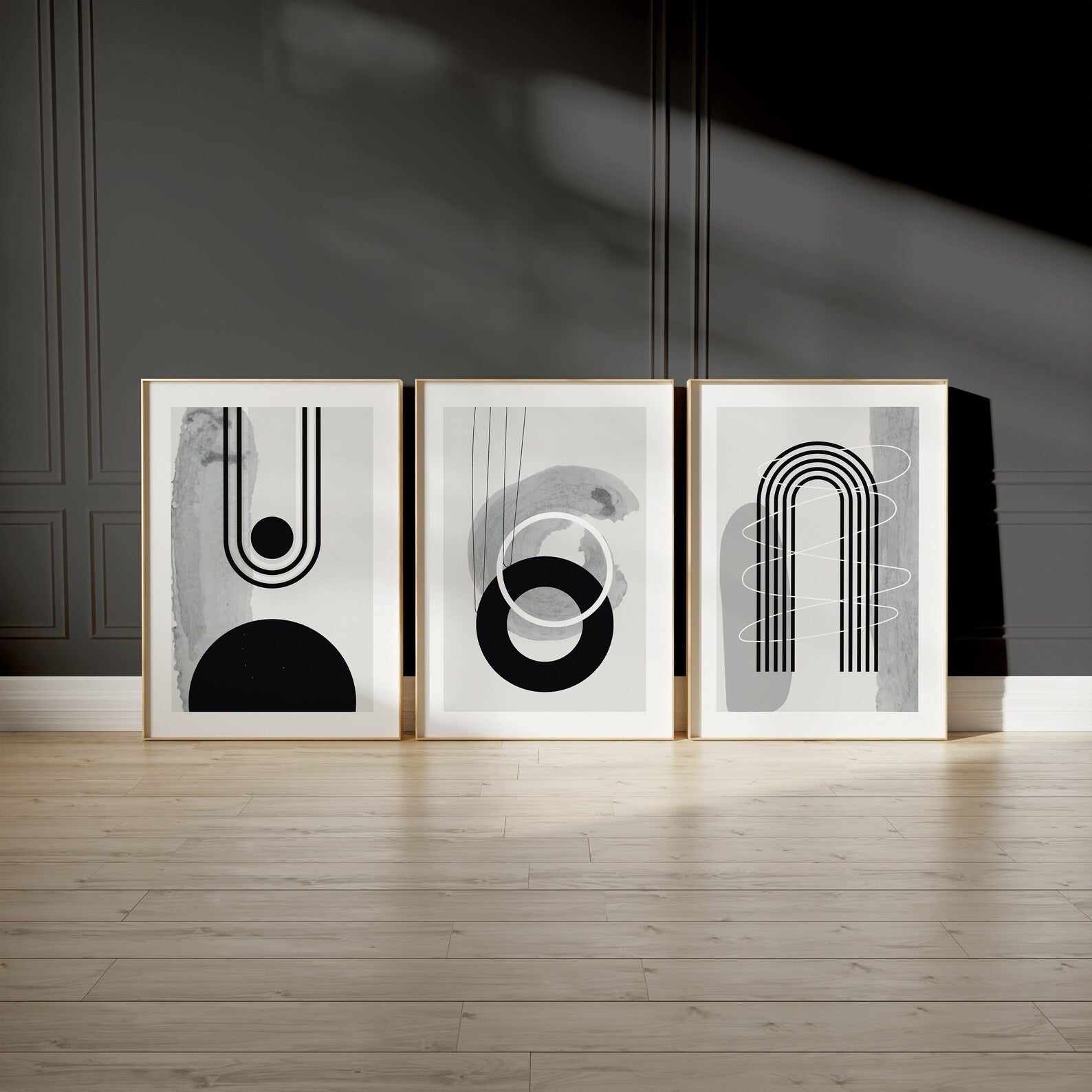 Set of 3 black and grey abstract prints featuring modern geometric line art, perfect for living room wall decor or contemporary home design.